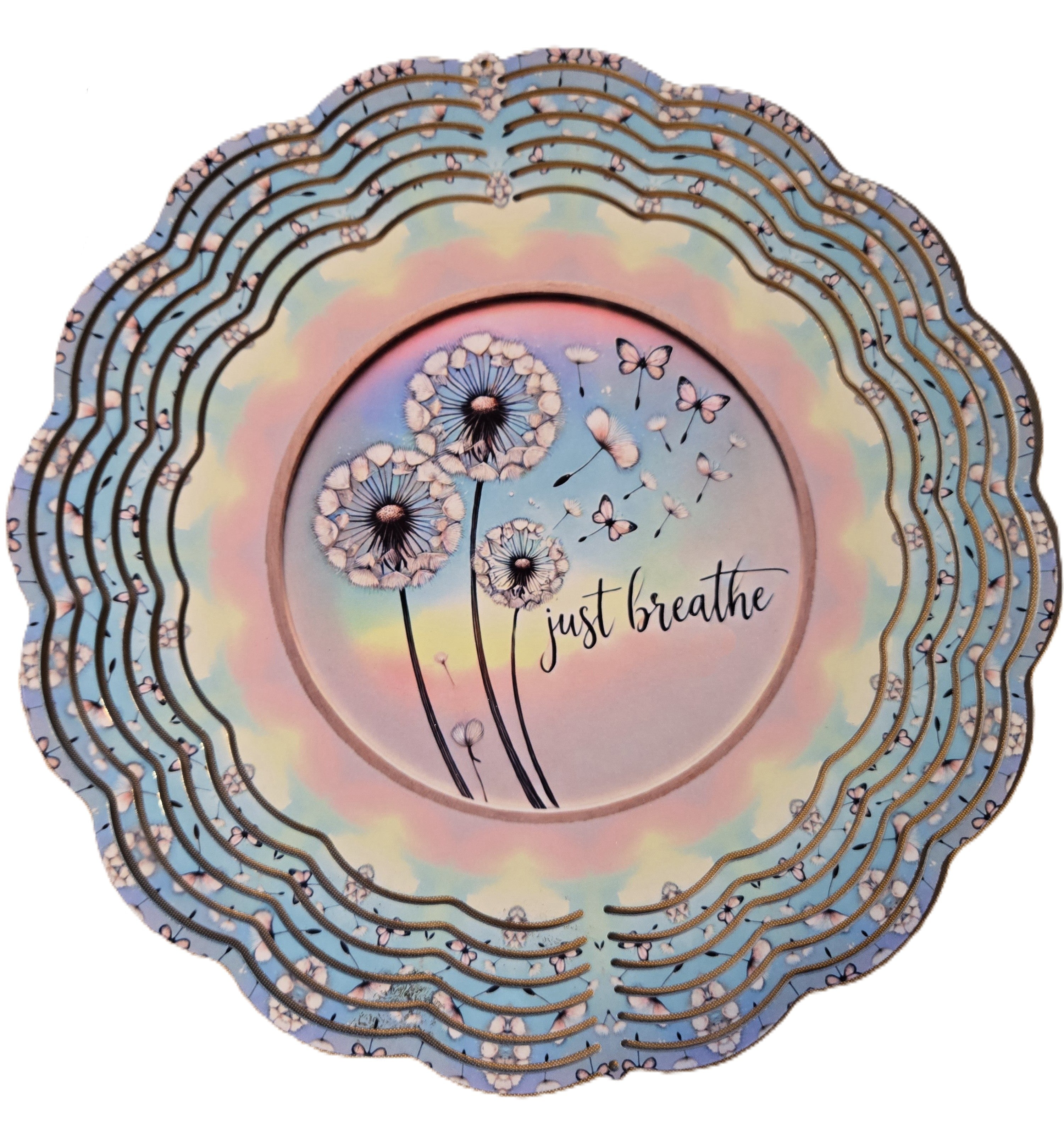 Decorative plate with dandelion design and 'just breathe' text on a colorful background